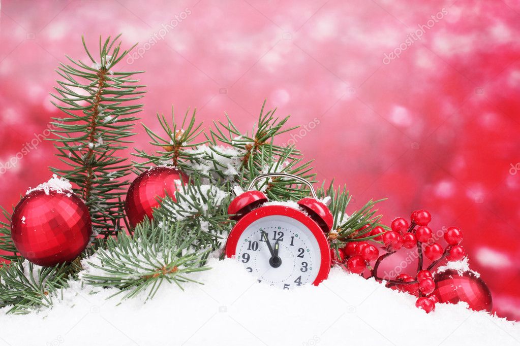 Green Christmas tree with toy and clock in the snow on red