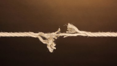 Breaking rope on brown background clipart
