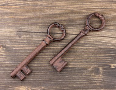 Two antique key on wooden background clipart