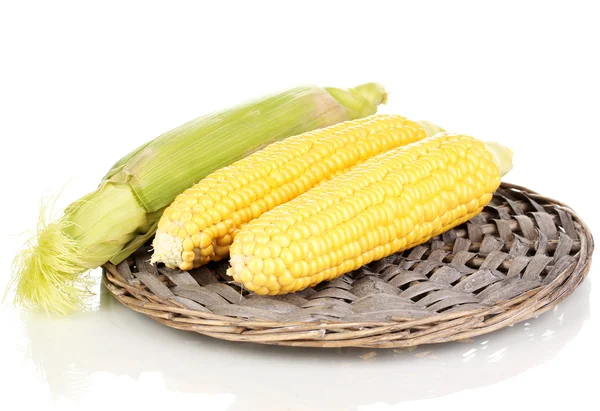 Fresh corn cobs on wicker mat isolated on white — Stock Photo, Image