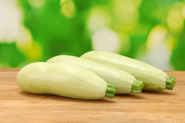 Squash on wooden table on green background close-up — Stock Photo, Image