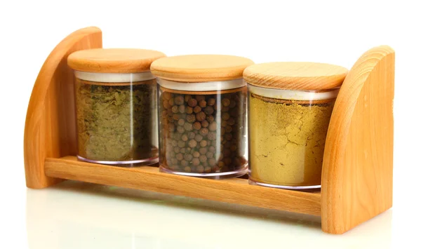 Jars with spices on wooden shelf isolated on white — Stock Photo, Image