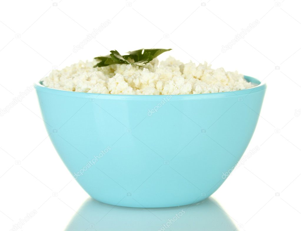 Cottage cheese with parsley in blue bowl isolated on white