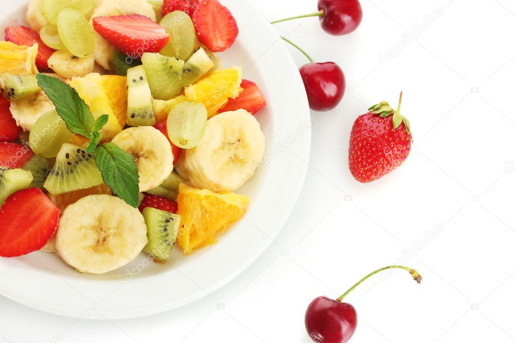 Fresh fruits salad on plate and berries isolated on white