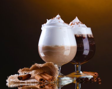 Glasses of coffee cocktail on brown background clipart