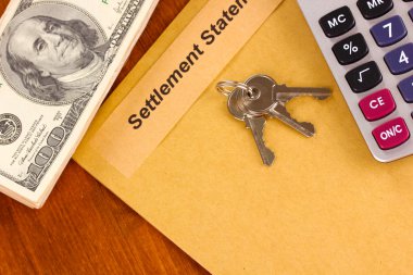 Folder with the settlement statement on wooden background close-up clipart