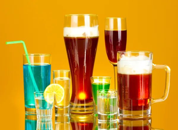 stock image A variety of alcoholic drinks on yellow background