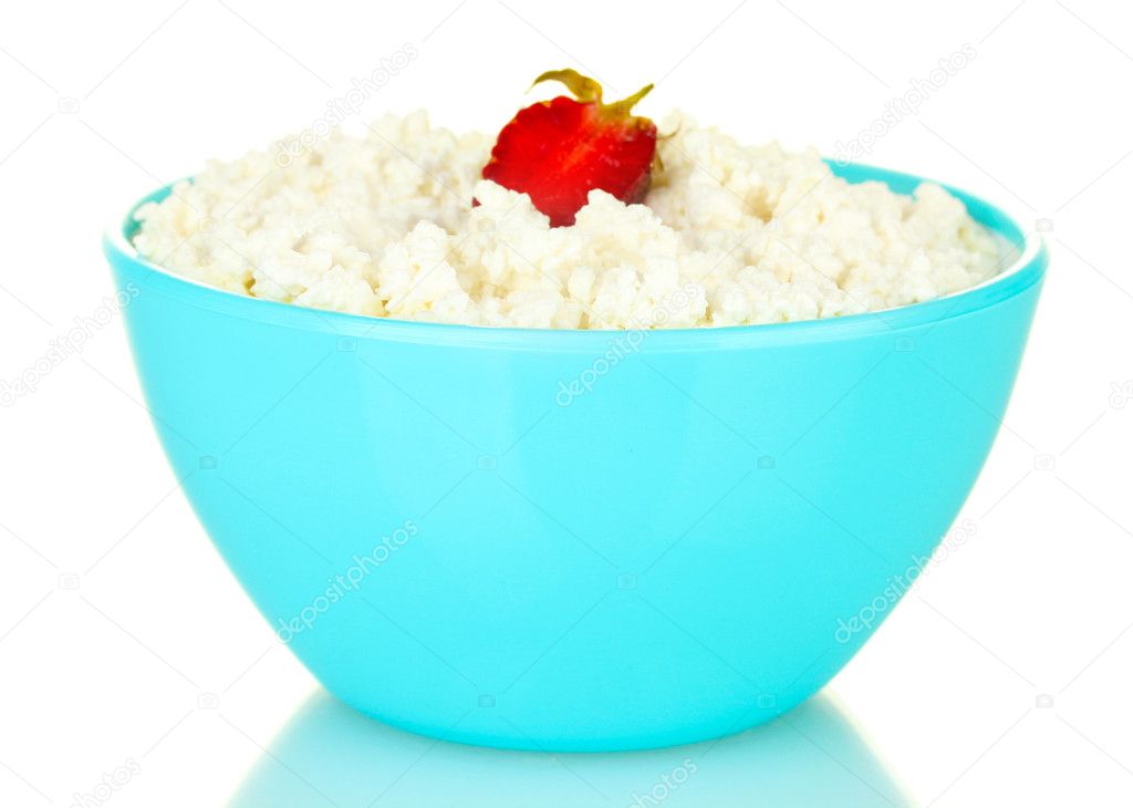 Cottage cheese with strawberry in blue bowl isolated on white