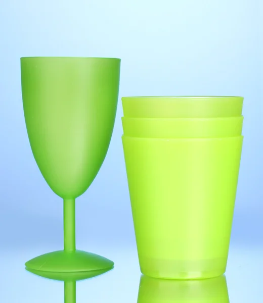 Bright plastic tableware on blue background — Stock Photo, Image