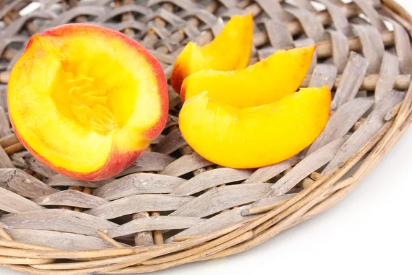 stock image Ripe peaches on wicker mat close-up