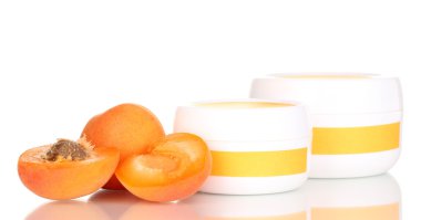 Jars of cream with juicy apricot isolated on white clipart