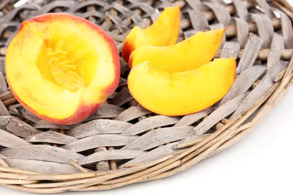 stock image Ripe peaches on wicker mat close-up