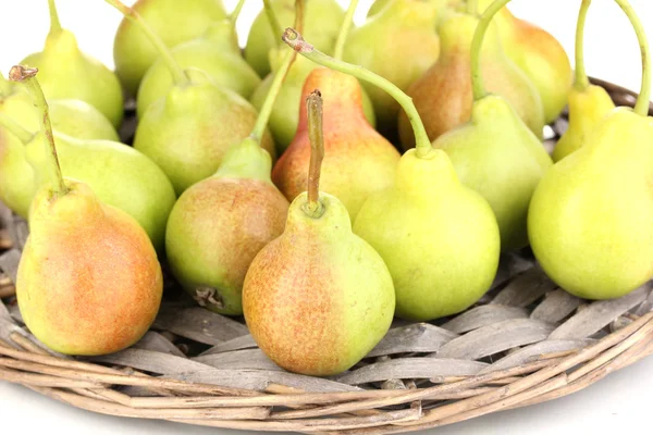 Ripe pears on wicker mat isolated on white — Stock Photo, Image