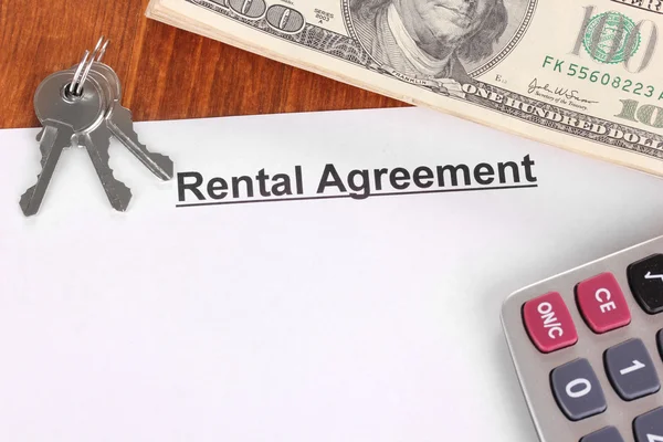 Rental agreement with dollars on wooden background close-up — Stock Photo, Image