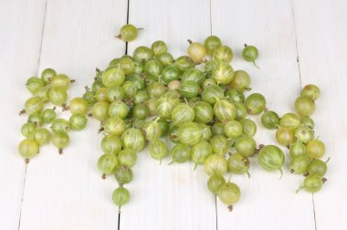 Green gooseberry on wooden background clipart