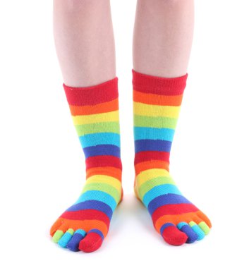 Female legs in colorful striped socks isolated on white clipart