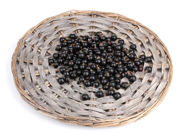 Black currant on wicker mat isolated on white — Stock Photo, Image