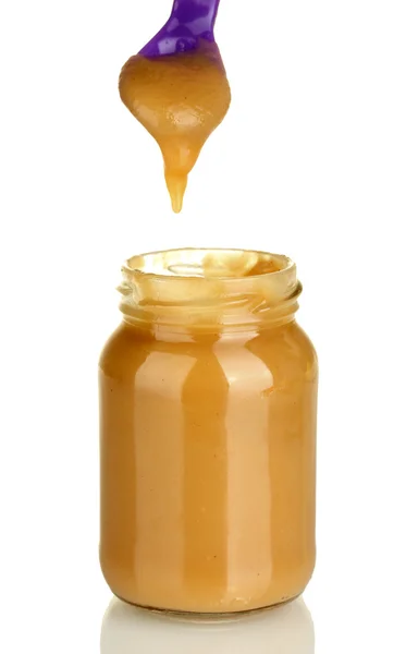 Jar with baby food and spoon on white background close-up — Stock Photo, Image