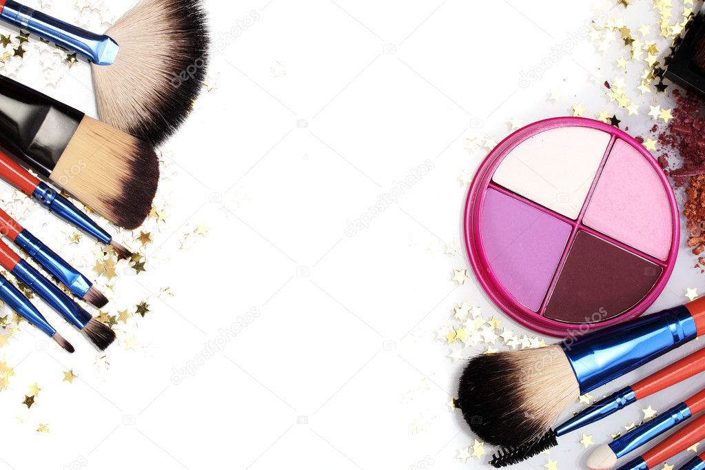 Make-up brushes in holder and cosmetics isolated on white