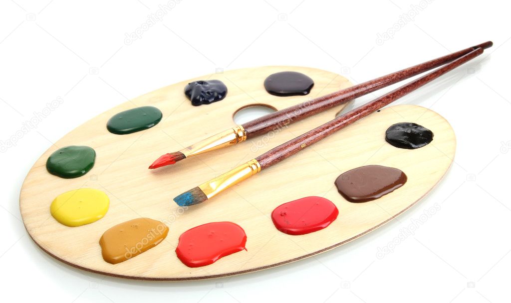 Wooden art palette with paint and brushesisolated on white