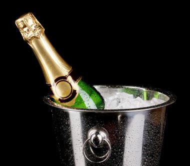 Bottle of champagne in bucket isolated on black clipart