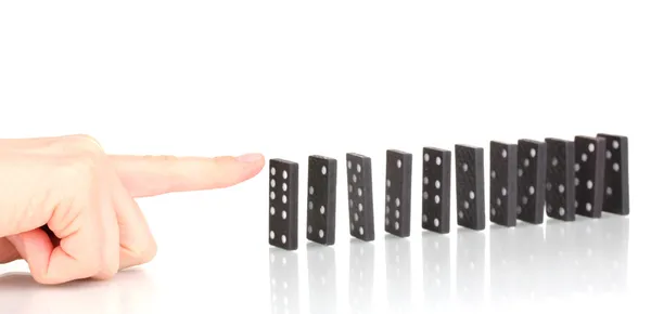 Hand pushing dominoes isolated on white — Stock Photo, Image