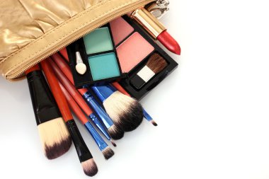 Make up bag with cosmetics and brushes isolated on white clipart