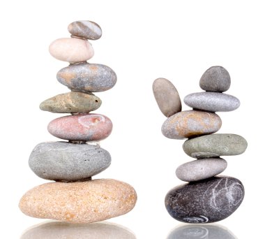 Stacks of balanced stones isolated on white clipart