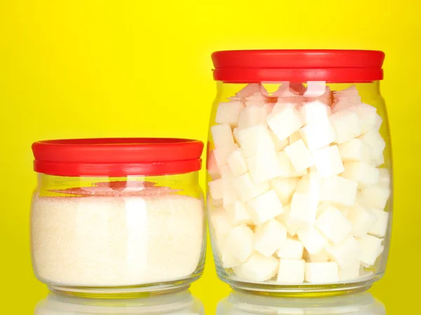 Frascos con azúcar en terrón blanco y azúcar cristalina blanca sobre fondo colorido — Foto de Stock