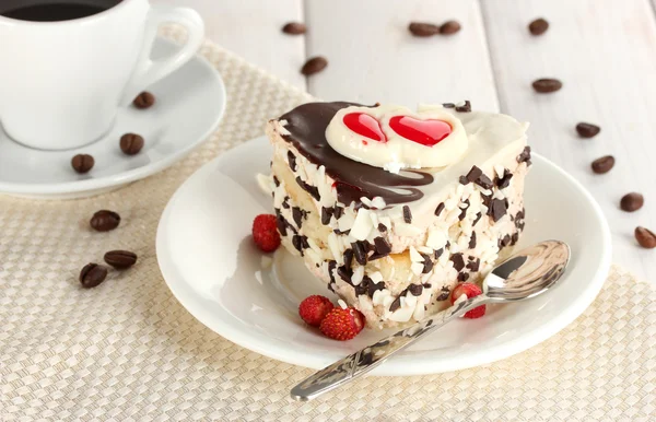 stock image Sweet cake with chocolate on plate and cup of coffee on wooden table