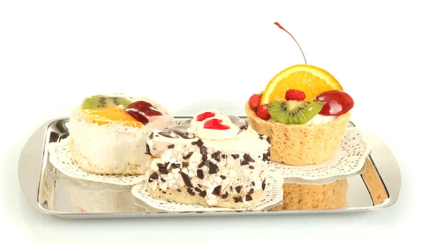 Tortas dulces con frutas y chocolate en bandeja de plata aislada en blanco — Foto de Stock