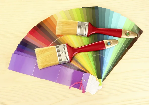 Penslar och ljusa palett av färger på trä bakgrund — Stockfoto