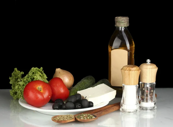 Ingredients for a Greek salad on black background — Stock Photo, Image