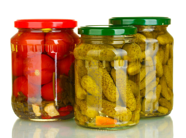 Jars of canned vegetables isolated on white