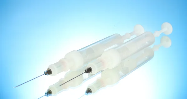 Syringes monovet on blue background — Stock Photo, Image