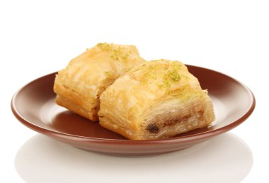 Sweet baklava on plate isolated on white clipart