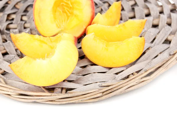 stock image Ripe peaches on wicker mat close-up