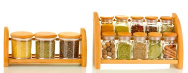 Jars with spices on wooden shelfs isolated on white clipart