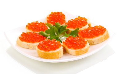 Red caviar on bread on white plate isolated on white clipart