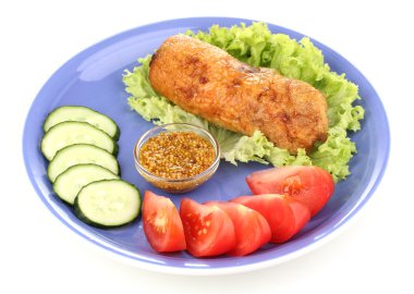 Tasty meat cutlet with garnish on plate isolated on white