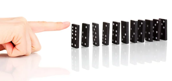 Hand pushing dominoes isolated on white — Stock Photo, Image