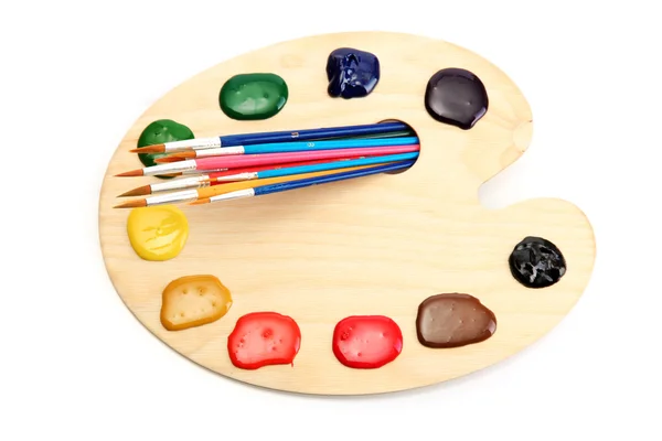 Wooden art palette with paint and brushesisolated on white — Stock Photo, Image