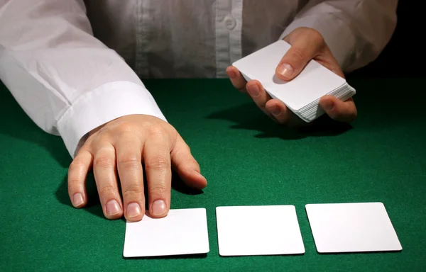 Cartões em mãos na mesa verde — Fotografia de Stock