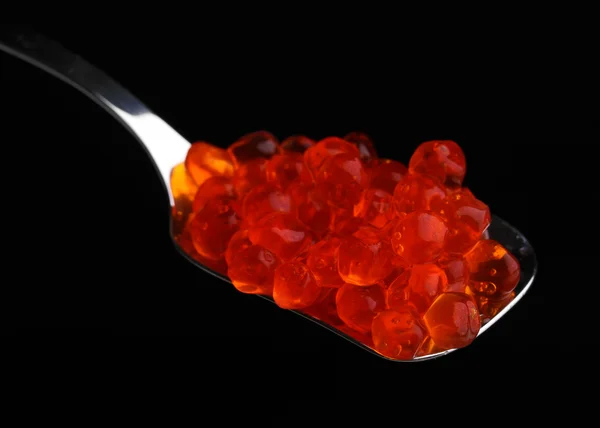 stock image Red caviar in silver spoon isolated on white