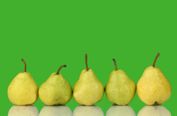Ripe pears on bright green background — Stock Photo, Image