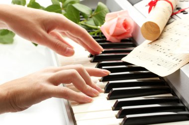 Hands of woman playing synthesizer clipart