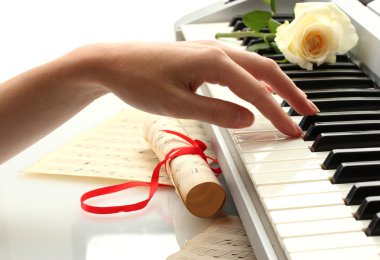 Hand of woman playing piano clipart