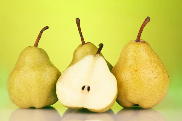 Ripe pears on bright green background — Stock Photo, Image