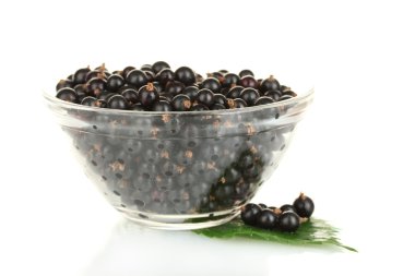 Fresh black currant in transparent bowl isolated on white