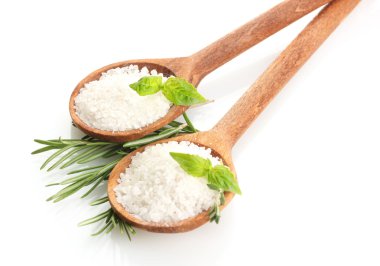 Salt in spoons with fresh basil, thyme and rosemary isolated on white clipart